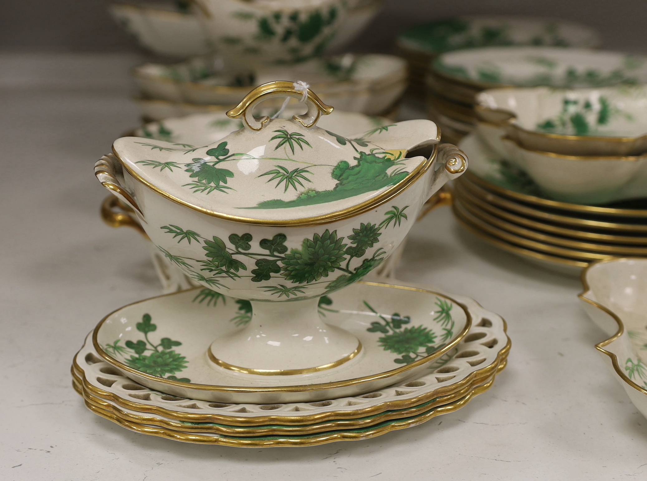 An early 19th century thirty-six piece part dessert service decorated with flowers, the largest 30cm wide